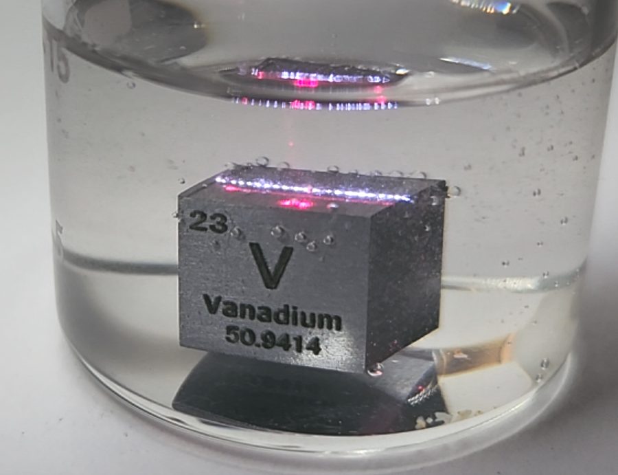 Vanadium cube submerged in liquid with a laser spot