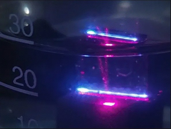 Two laser beams crossing a liquid-filled vessel during nanoparticle synthesis
